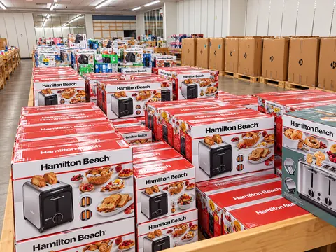 Stacks of boxed Hamilton Beach toasters on a wooden display